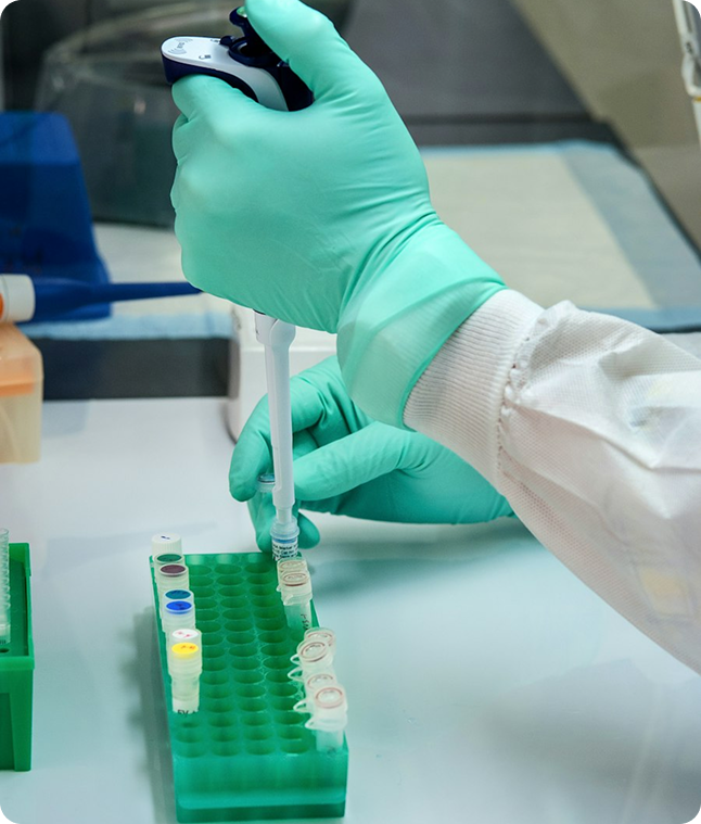 Clinical researcher using a pipette to prepare samples in a laboratory